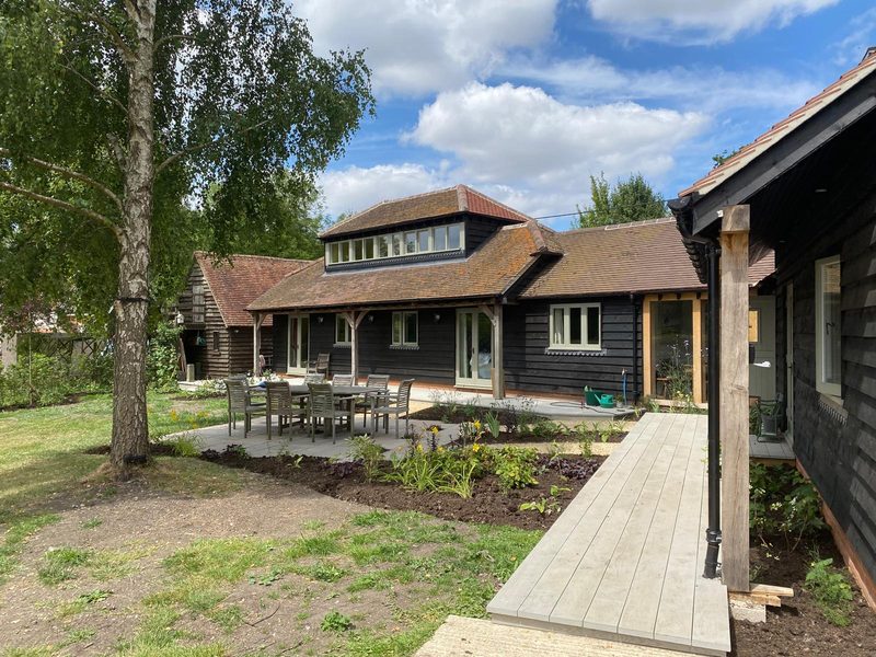 Wide view of the finished barn conversion garden with new paths and lawn